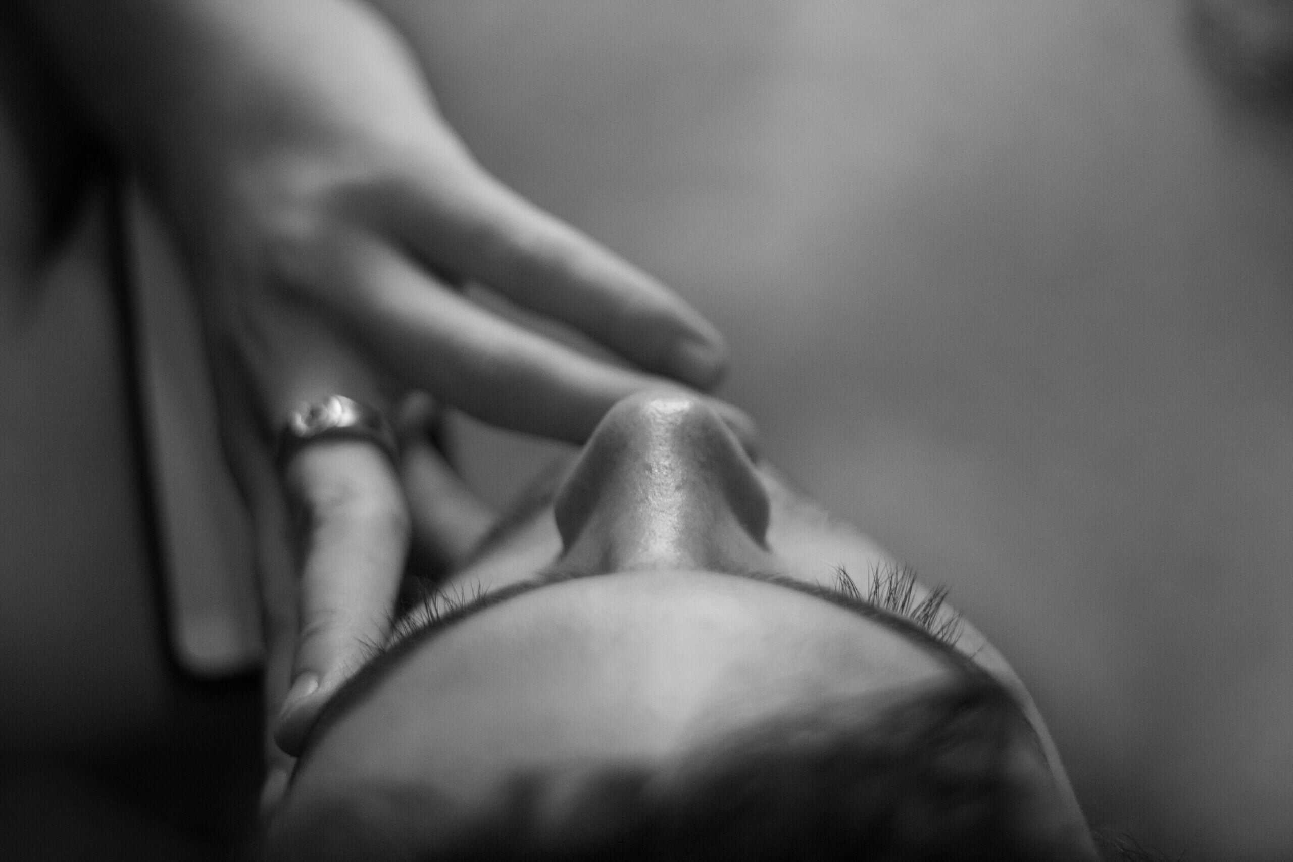 A shot of the face from up and a hand on face and a ring and a tiny nose