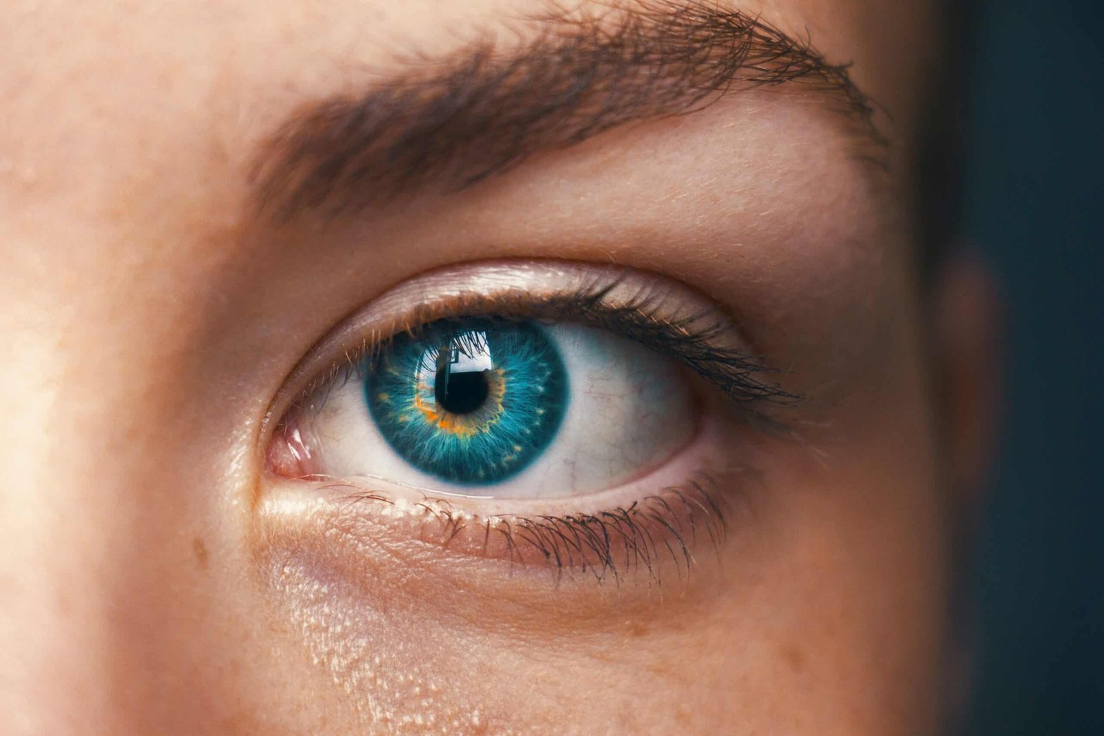 A woman with a green eye staring at a point