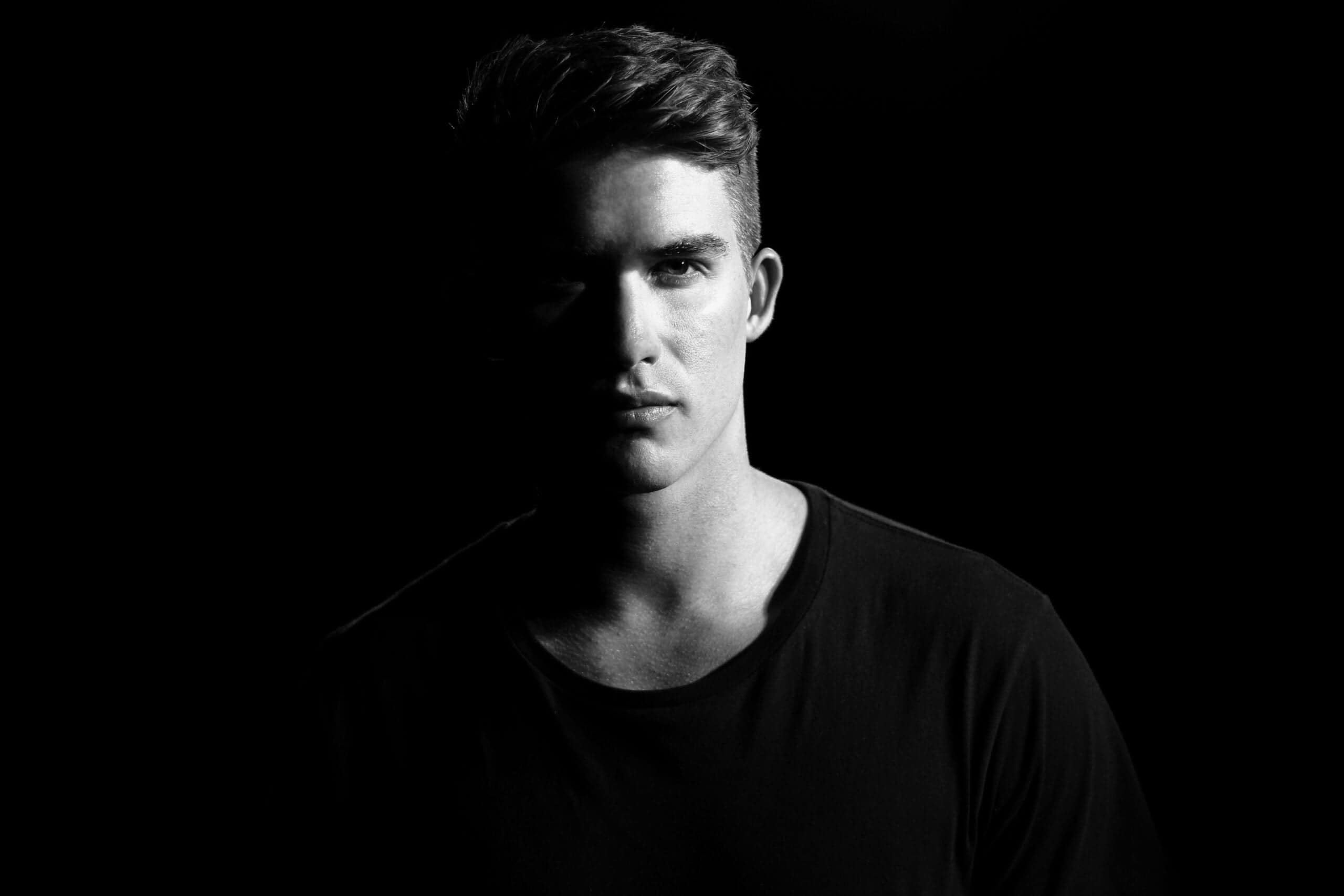 A young man wearing a black shirt with nice hair