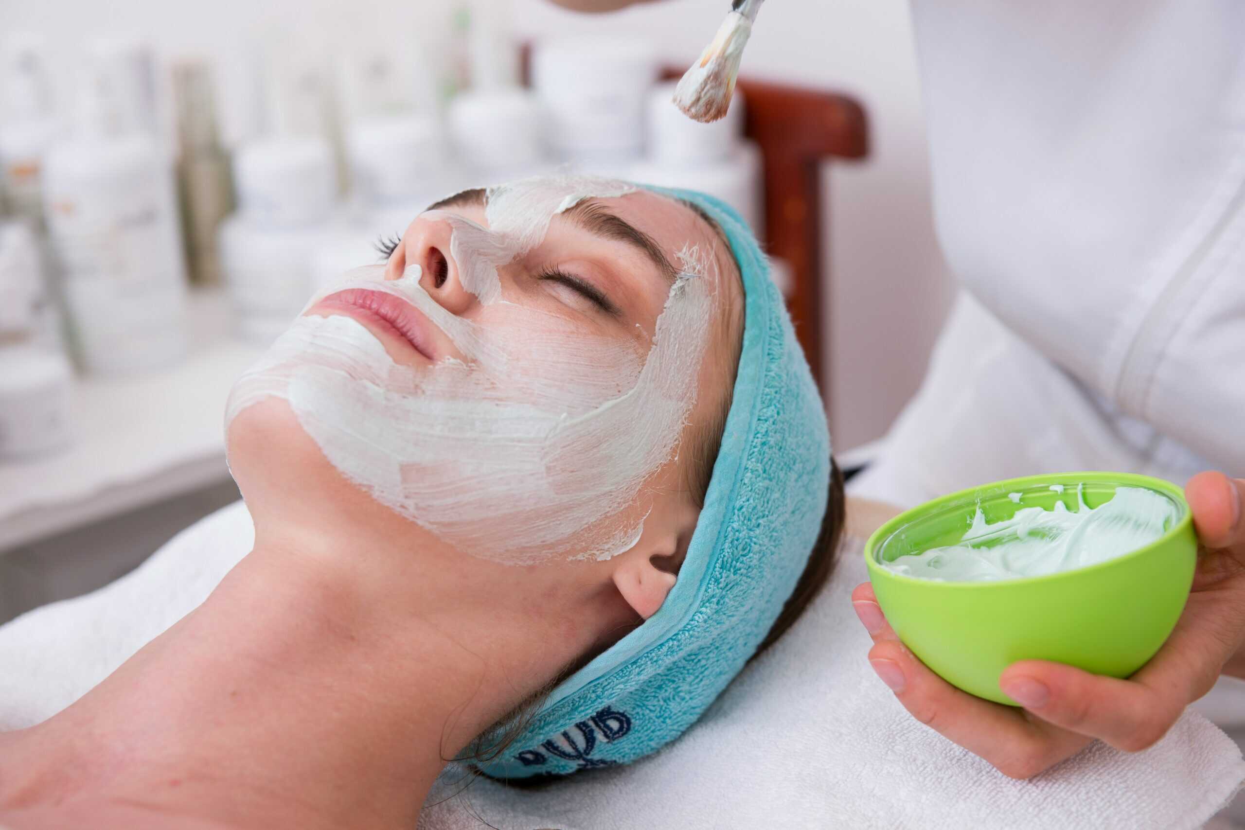 A woman applying rejuvenating skin care materials on her face