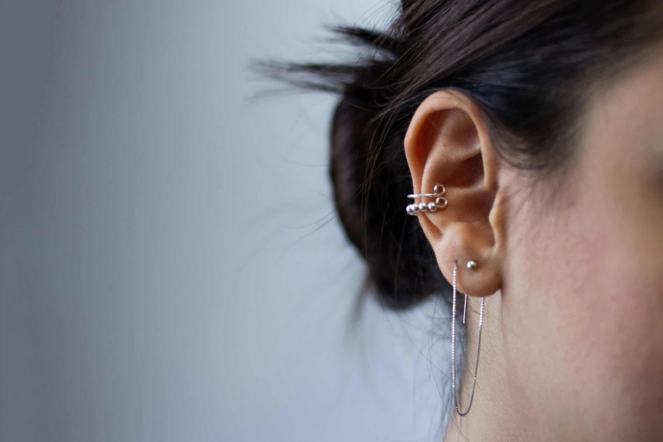 A woman wearing earrings and a necklace.