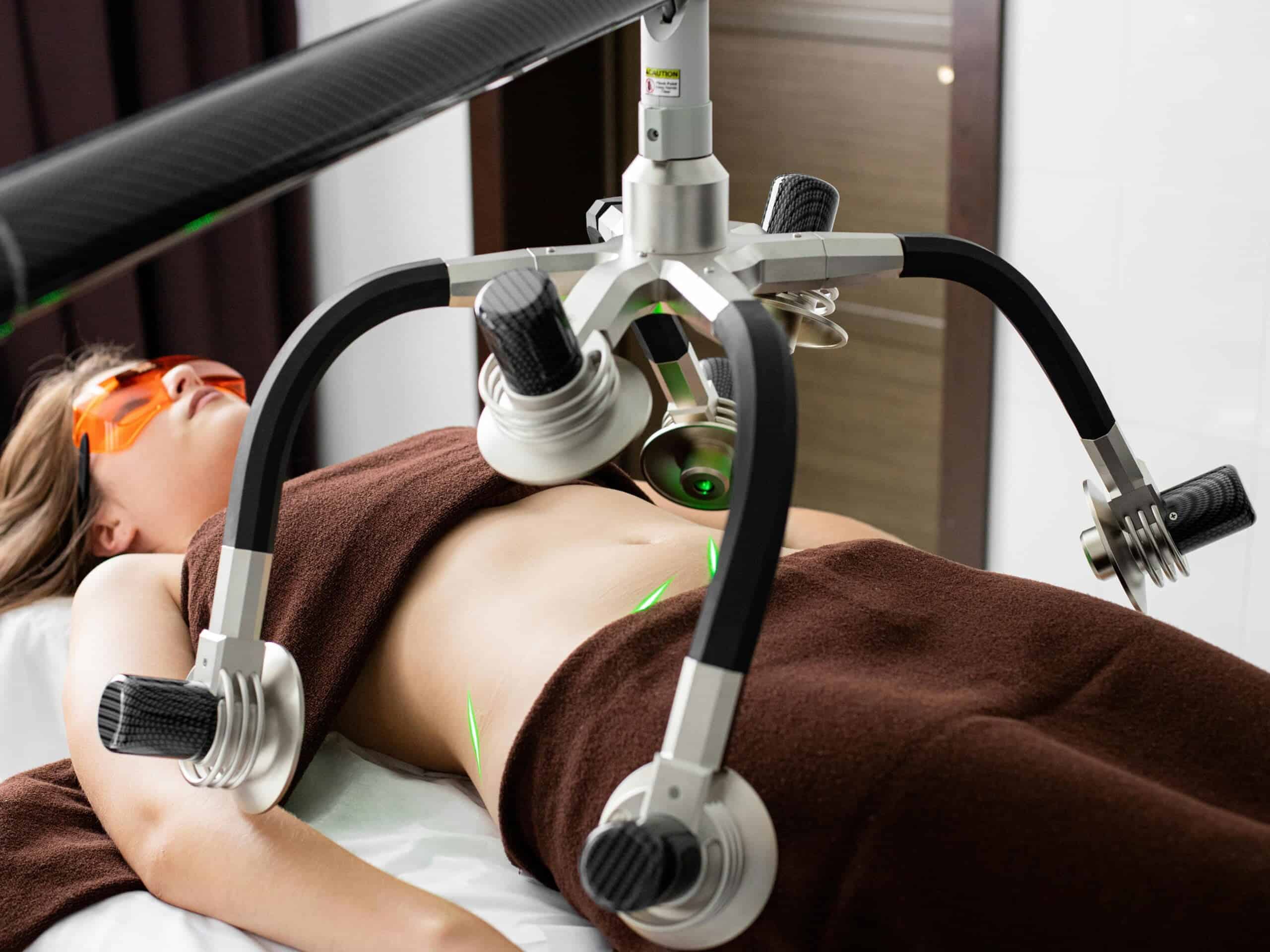 Woman receiving liposuction treatment in a modern clinic