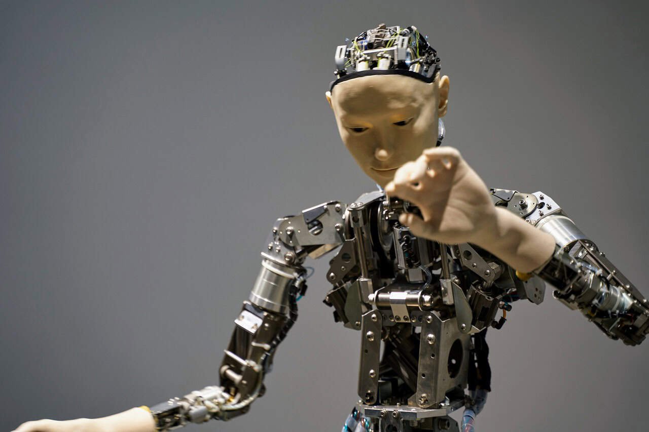 A robot with a metal body and a hand.