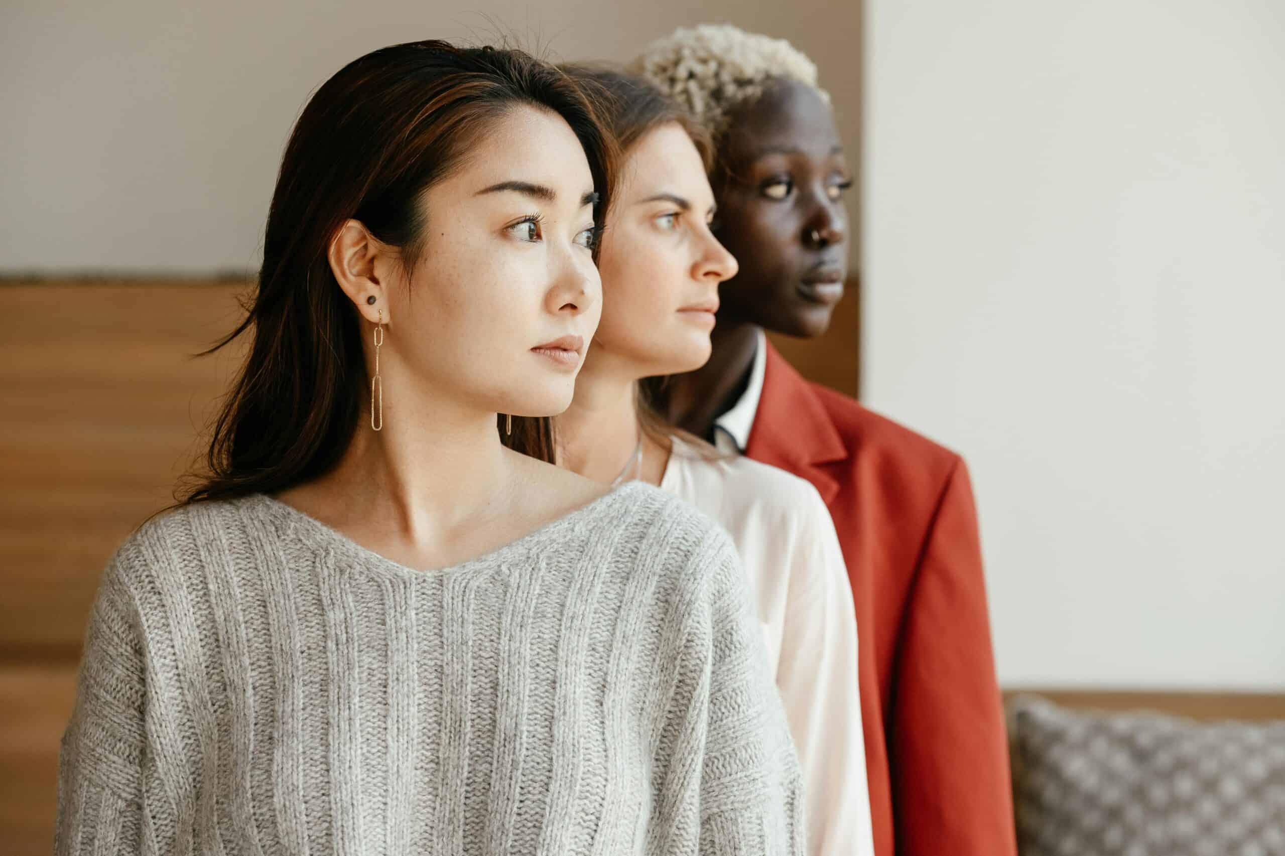 women standing side by side with different ethnicity